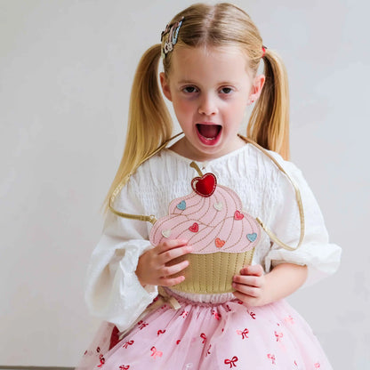 Dettaglio borsetta cupcake bambina rosa glitter con ciliegina