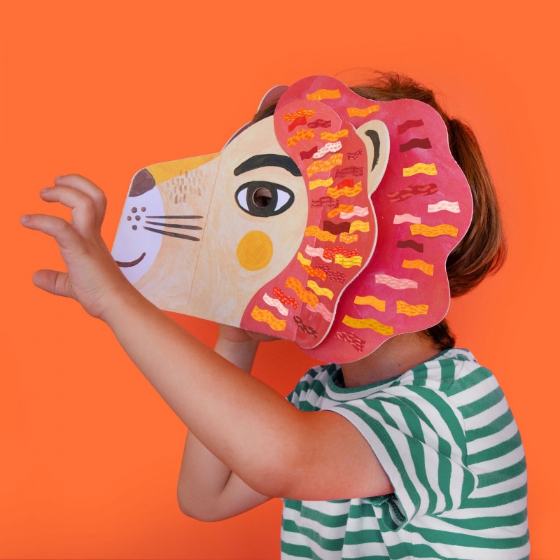 Bambino che indossa e decora la maschera Leone Londji con adesivi, gioco creativo sostenibile