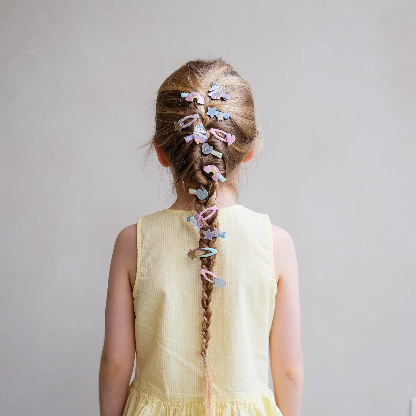 Bambina con fermagli clic clac unicorno glitter